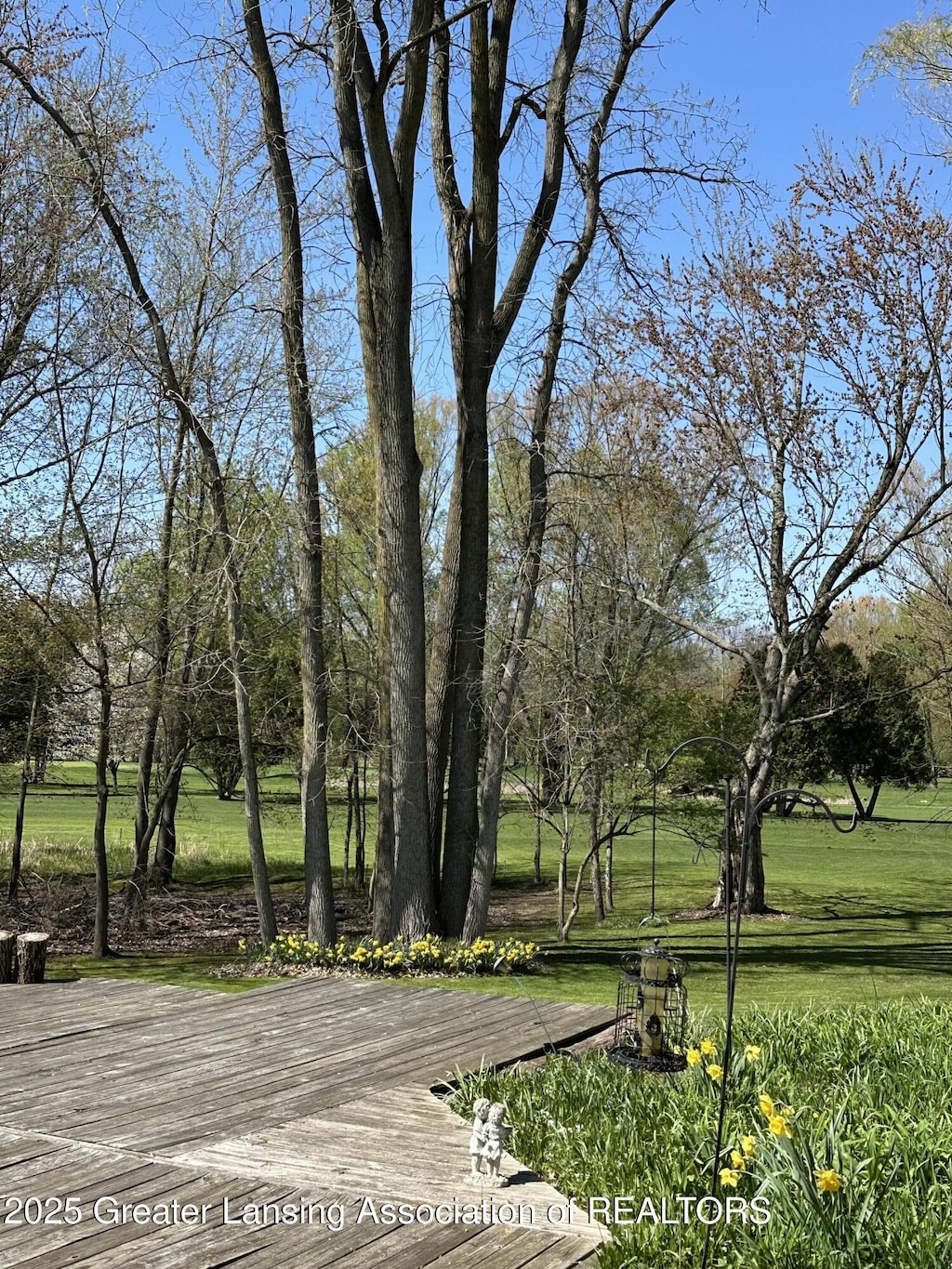 view of property's community with a lawn and a wooden deck
