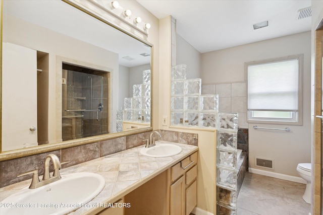4793 Ottawa Dr, Okemos, MI 48864 - full bathroom with tiled shower, double vanity, toilet, tile patterned floors, and a tub to relax in