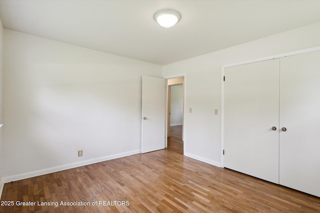 4793 Ottawa Dr, Okemos, MI 48864 - unfurnished bedroom featuring light wood-style floors, baseboards, and a closet