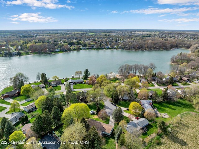 drone / aerial view with a residential view and a water view