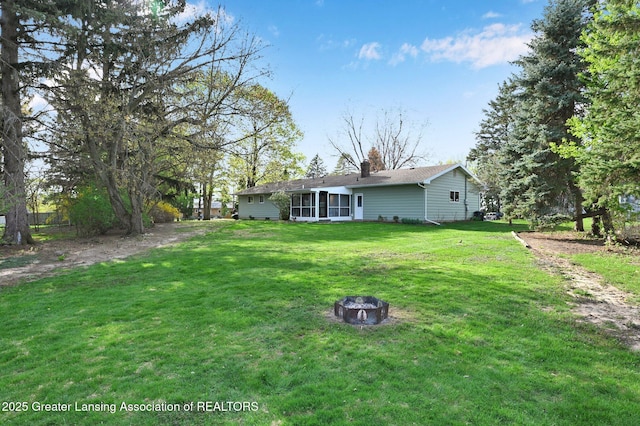 view of yard featuring an outdoor fire pit