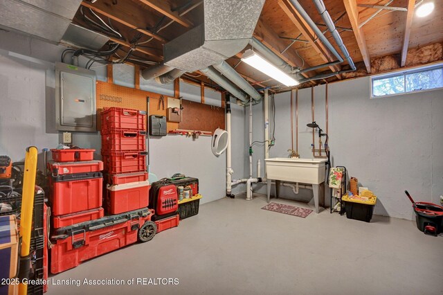 below grade area with a sink and electric panel