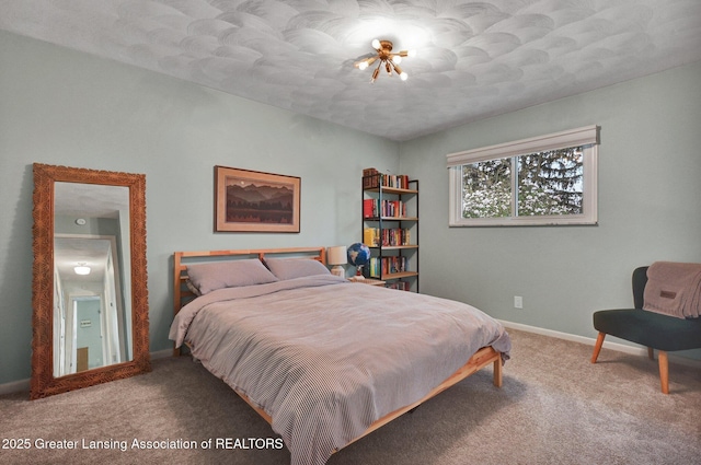 carpeted bedroom featuring baseboards