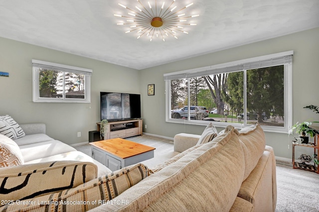 living area featuring light colored carpet, baseboards, and plenty of natural light