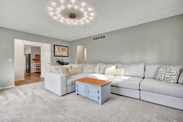 living room with light colored carpet, a notable chandelier, visible vents, and baseboards