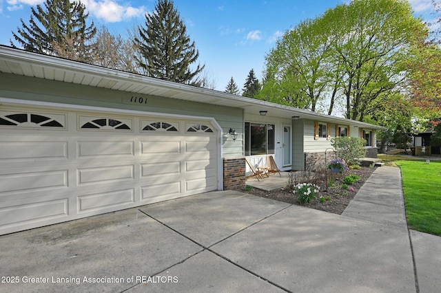 ranch-style home with an attached garage, driveway, and brick siding