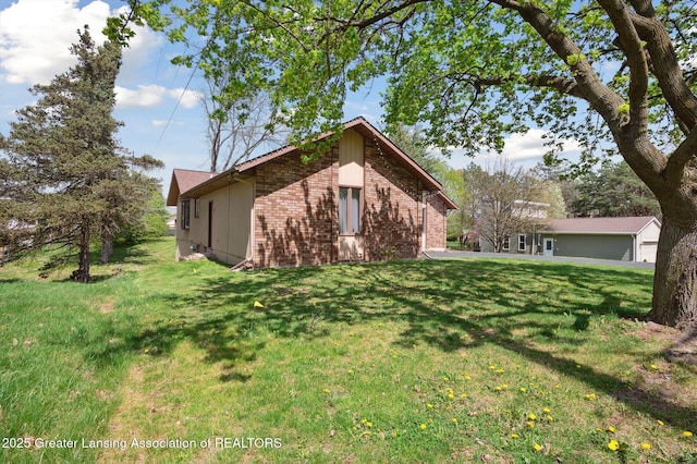 view of side of home with brick siding and a lawn