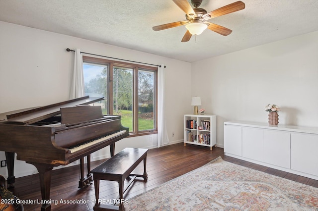 sitting room with a textured ceiling, baseboards, a ceiling fan, and hardwood / wood-style floors