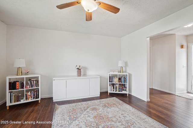 game room featuring baseboards, ceiling fan, and hardwood / wood-style floors