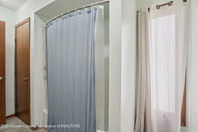 bathroom featuring shower / bath combo with shower curtain