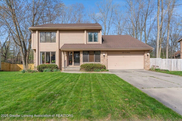 traditional-style home featuring fence, an attached garage, concrete driveway, and a front yard