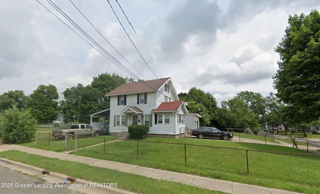 colonial inspired home featuring a fenced front yard and a front yard