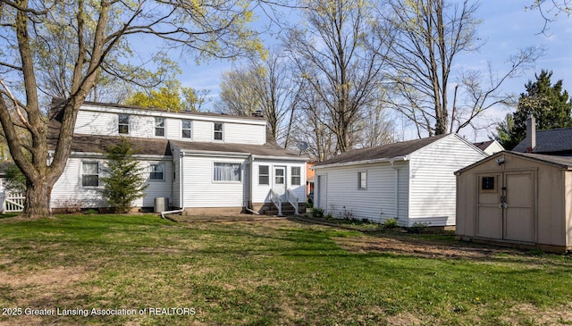 rear view of property featuring a storage unit, a yard, an outbuilding, and entry steps