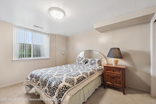 bedroom with baseboards, light colored carpet, and visible vents