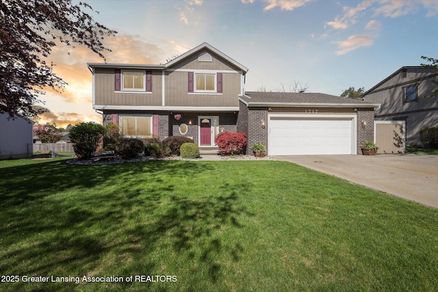 view of front facade with a lawn, brick siding, fence, concrete driveway, and an attached garage