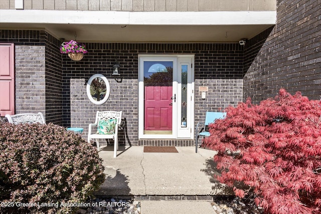 doorway to property featuring brick siding