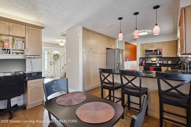 dining room with tile patterned floors, stairs, and a textured ceiling