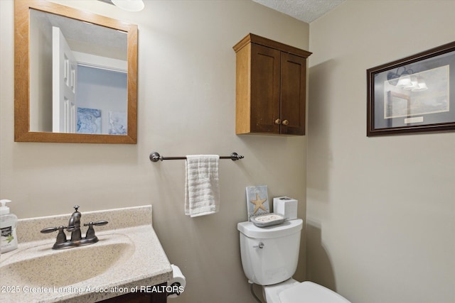 bathroom with toilet and vanity