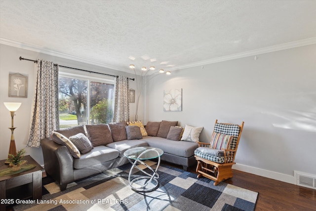 living room with visible vents, ornamental molding, baseboards, and wood finished floors