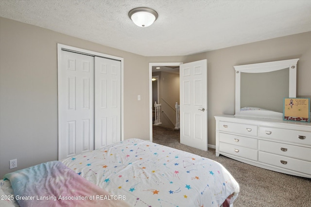 carpeted bedroom with a closet and a textured ceiling