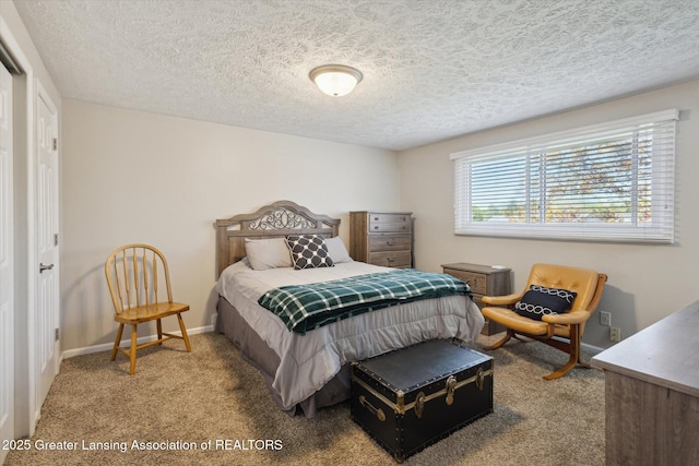carpeted bedroom with baseboards and a textured ceiling