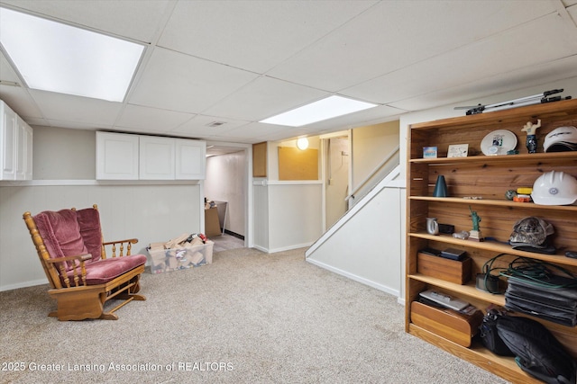sitting room featuring light colored carpet and a paneled ceiling