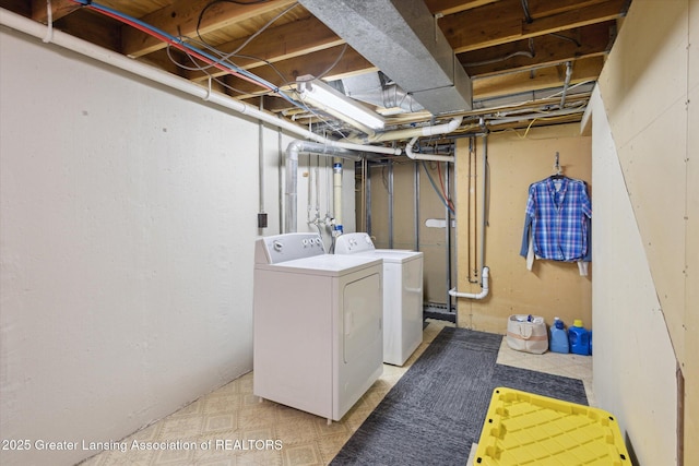 laundry room with laundry area, light floors, and washing machine and dryer