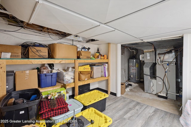 storage room with heating unit and gas water heater