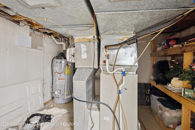 utility room with heating unit and gas water heater