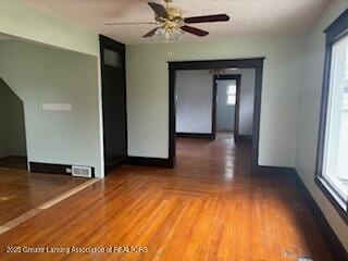 512 S Cedar St, Owosso, MI 48867 - spare room with ceiling fan, wood finished floors, and a healthy amount of sunlight