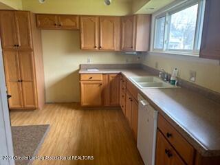 512 S Cedar St, Owosso, MI 48867 - kitchen with a sink, brown cabinetry, wood finished floors, and dishwasher