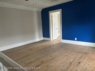 512 S Cedar St, Owosso, MI 48867 - spare room with baseboards, ceiling fan, and wood finished floors