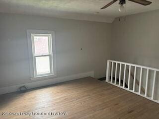 512 S Cedar St, Owosso, MI 48867 - spare room featuring ceiling fan and wood finished floors