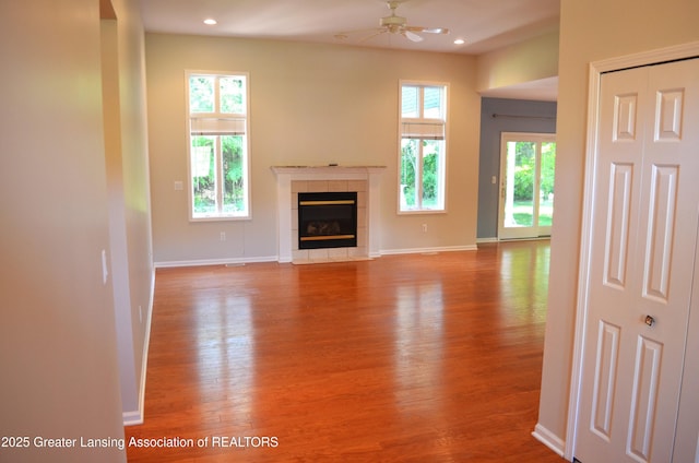 3401 N Burwick Dr, Port Huron, MI 48060 - unfurnished living room with wood finished floors, ceiling fan, a fireplace, plenty of natural light, and recessed lighting