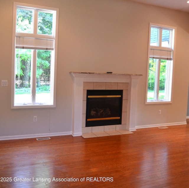 3401 N Burwick Dr, Port Huron, MI 48060 - unfurnished living room with wood finished floors, baseboards, and plenty of natural light