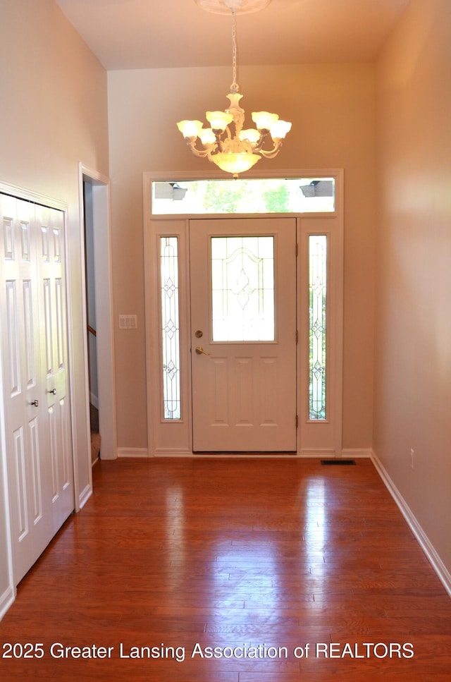 3401 N Burwick Dr, Port Huron, MI 48060 - entryway featuring a chandelier, wood finished floors, and baseboards