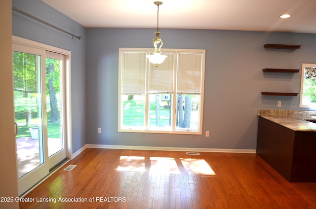 3401 N Burwick Dr, Port Huron, MI 48060 - unfurnished dining area with wood finished floors, baseboards, and recessed lighting