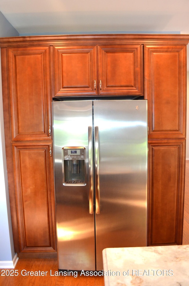 3401 N Burwick Dr, Port Huron, MI 48060 - kitchen featuring stainless steel refrigerator with ice dispenser, wood finished floors, and brown cabinetry