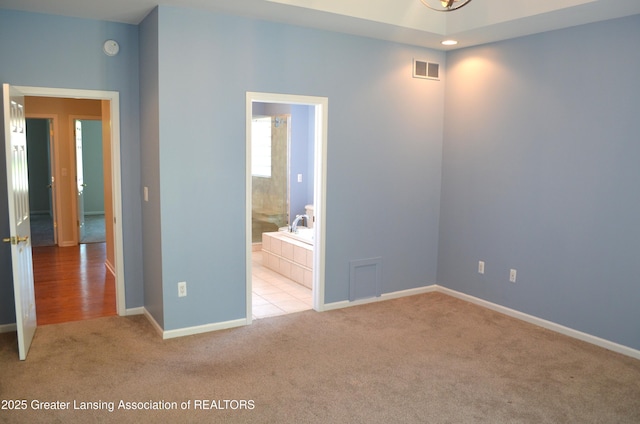 3401 N Burwick Dr, Port Huron, MI 48060 - unfurnished bedroom with carpet, baseboards, and ensuite bath