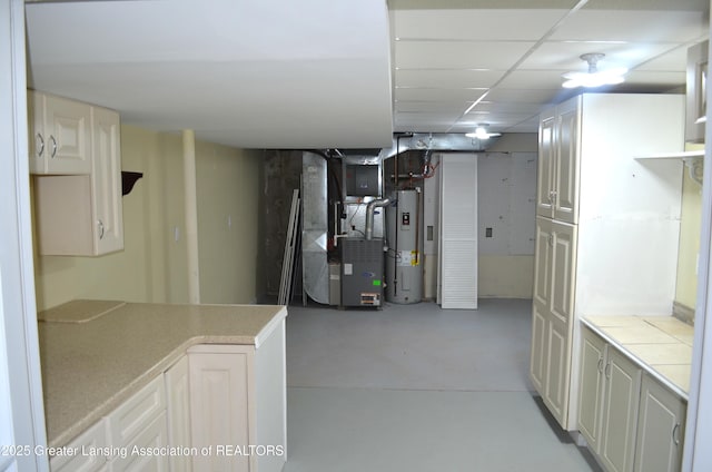 3401 N Burwick Dr, Port Huron, MI 48060 - finished below grade area featuring electric water heater, heating unit, and a drop ceiling