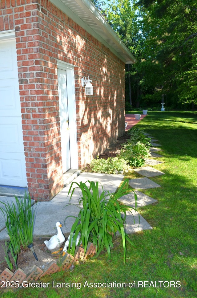 3401 N Burwick Dr, Port Huron, MI 48060 - view of exterior entry with brick siding and a yard