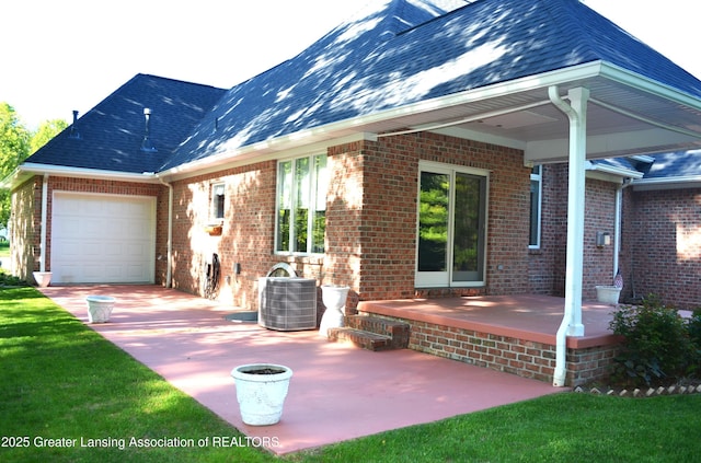 3401 N Burwick Dr, Port Huron, MI 48060 - rear view of property with central air condition unit, brick siding, a garage, and driveway