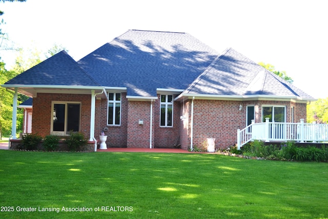3401 N Burwick Dr, Port Huron, MI 48060 - back of property featuring a yard, brick siding, a deck, and roof with shingles