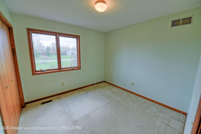 9408 W Scenic Lake Dr, Laingsburg, MI 48848 - unfurnished bedroom with light colored carpet, baseboards, and visible vents