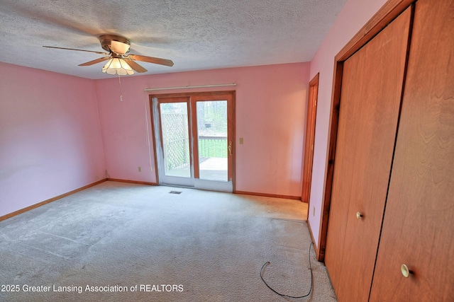 9408 W Scenic Lake Dr, Laingsburg, MI 48848 - unfurnished bedroom featuring a textured ceiling, access to exterior, baseboards, a closet, and light carpet