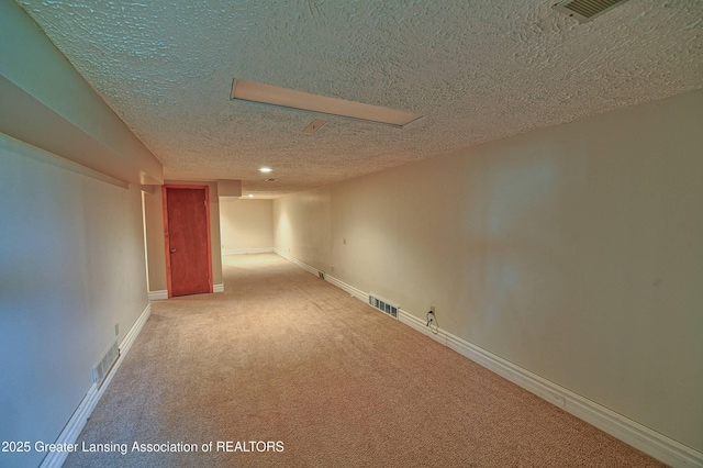 9408 W Scenic Lake Dr, Laingsburg, MI 48848 - finished below grade area with carpet flooring, a textured ceiling, and visible vents