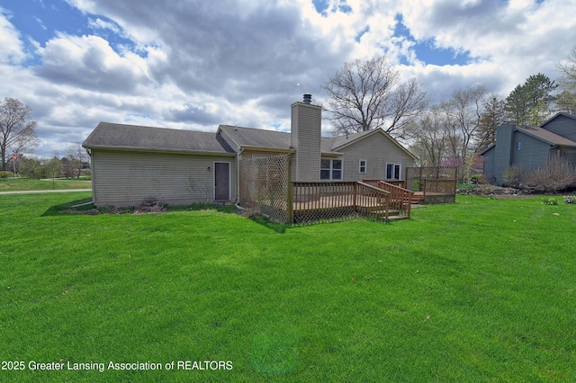 9408 W Scenic Lake Dr, Laingsburg, MI 48848 - back of house with a lawn, a wooden deck, and a chimney