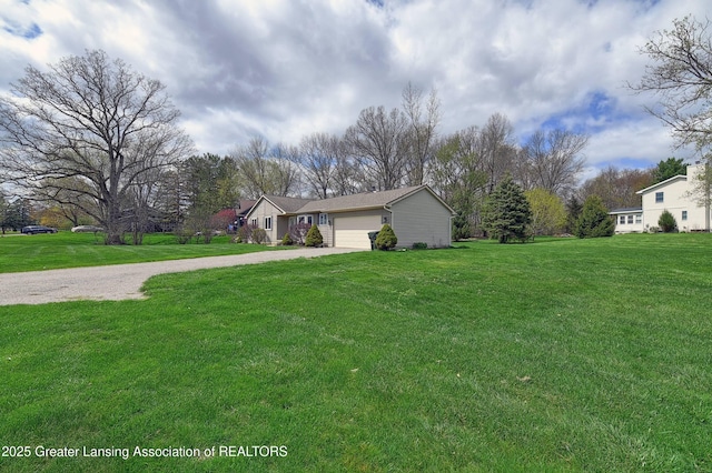 9408 W Scenic Lake Dr, Laingsburg, MI 48848 - view of front of home with an attached garage, driveway, and a front yard