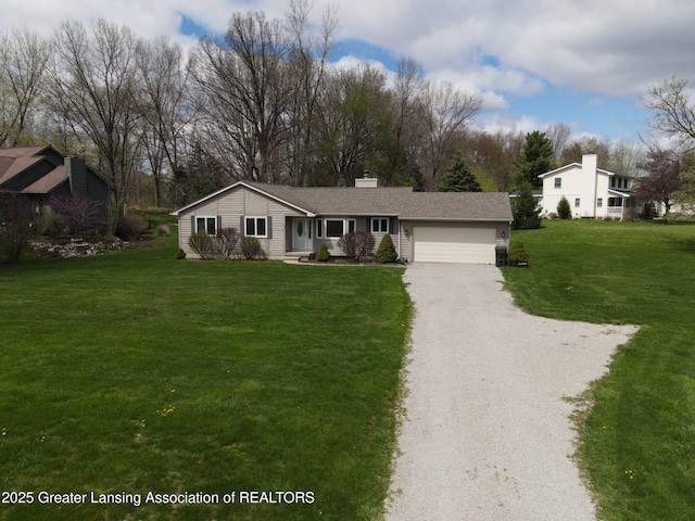 9408 W Scenic Lake Dr, Laingsburg, MI 48848 - ranch-style house with an attached garage, a chimney, driveway, and a front yard