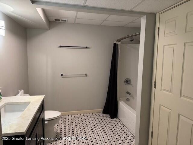 2434 Emerald Lake Dr, East Lansing, MI 48823 - bathroom with vanity, shower / bathtub combination with curtain, a paneled ceiling, and tile patterned floors